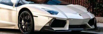 Elegant white sports car parked on a city street in Atlanta, showcasing luxury design.
