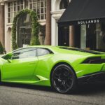 A vibrant lime green Lamborghini parked on a London street, showcasing luxury and style.